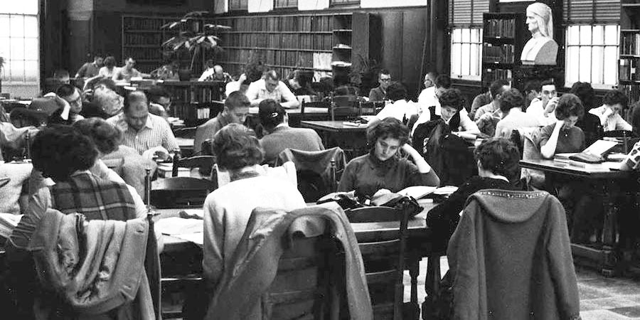 1930s black and white photo of WVU students studying in the library